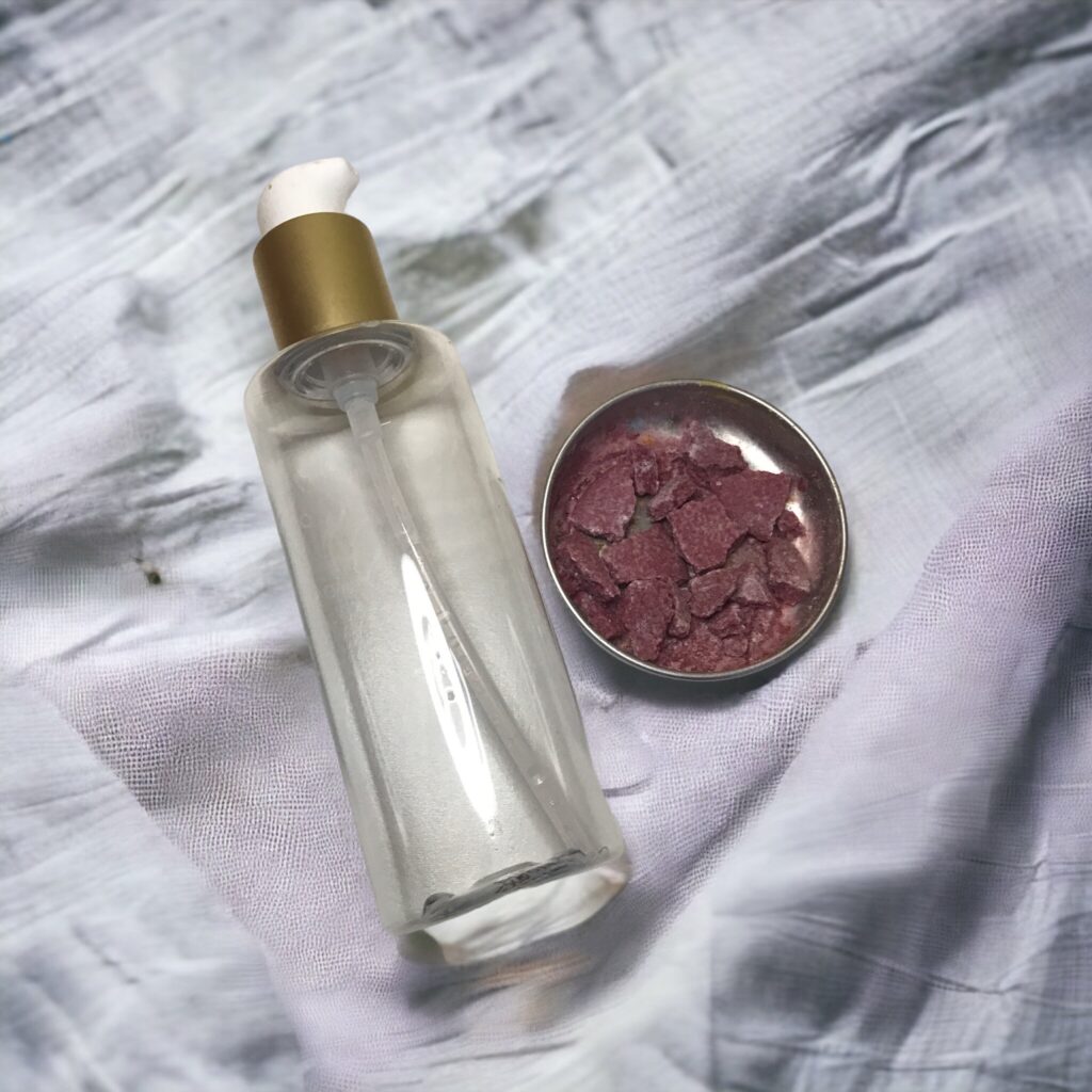 Empty container next to a round tin with shampoo bar pieces.